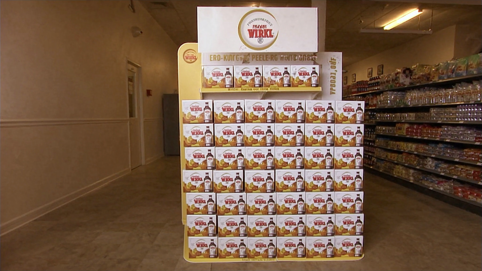 End-cap beer display in a convenience store with branded shelf signage — the visible outcome of accountable field execution at retail